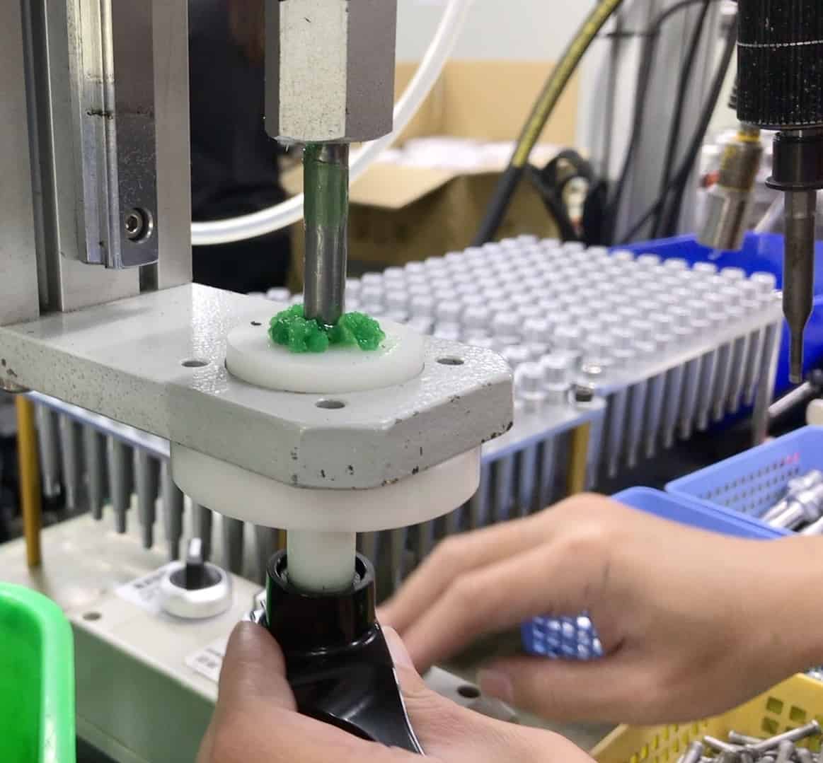 Automated grease injection prior to seating and pressing in the sealed bearing