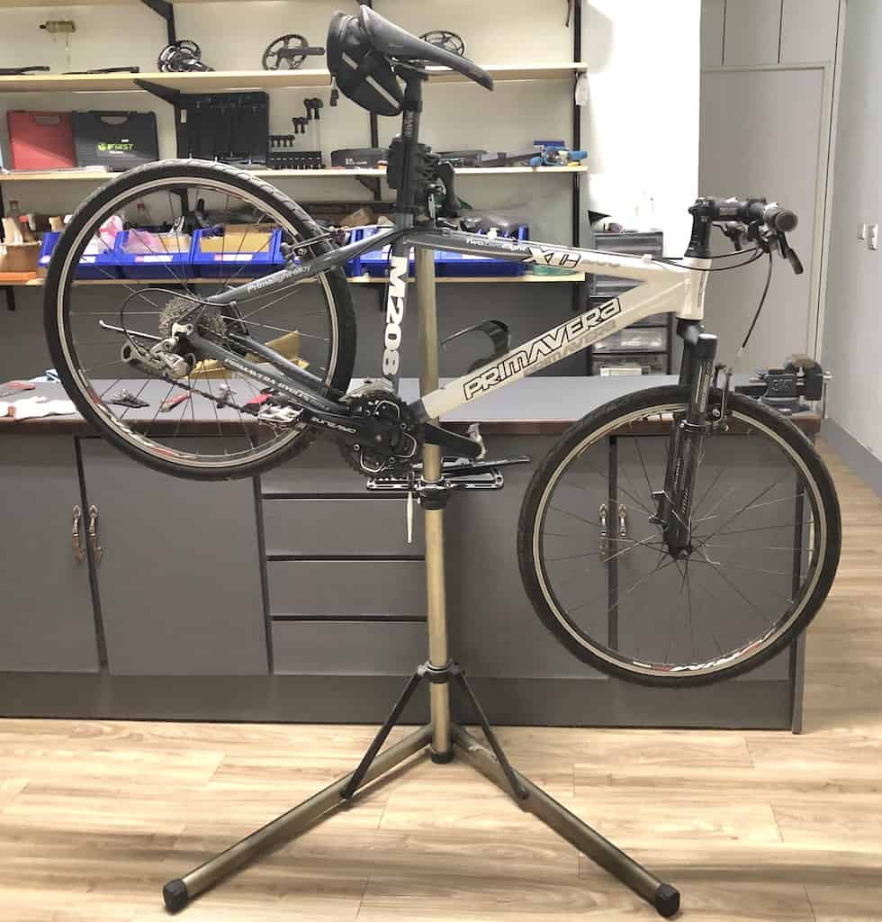 bike suspended on bike repair stand