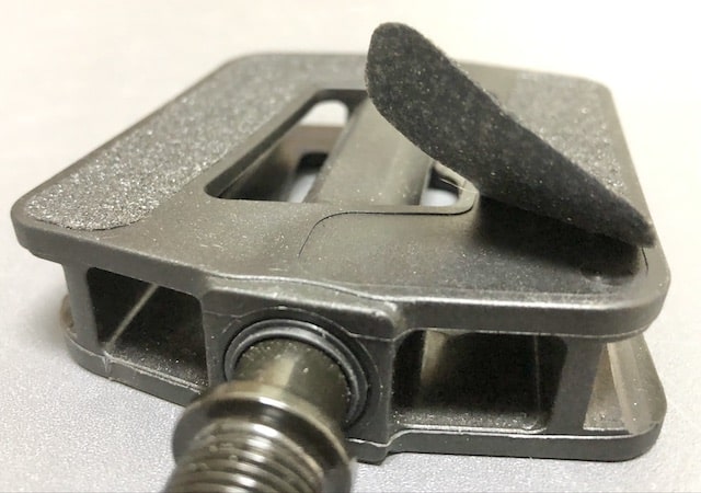 Bike pedal with sandpaper strip peeled back