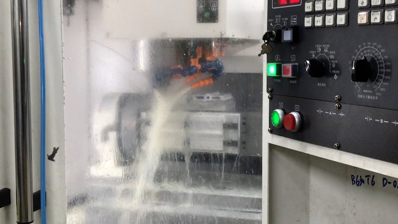 cnc machine fluid spraying inside cabinet